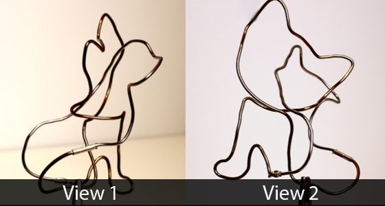 Wire figure of a cat seen from two angles