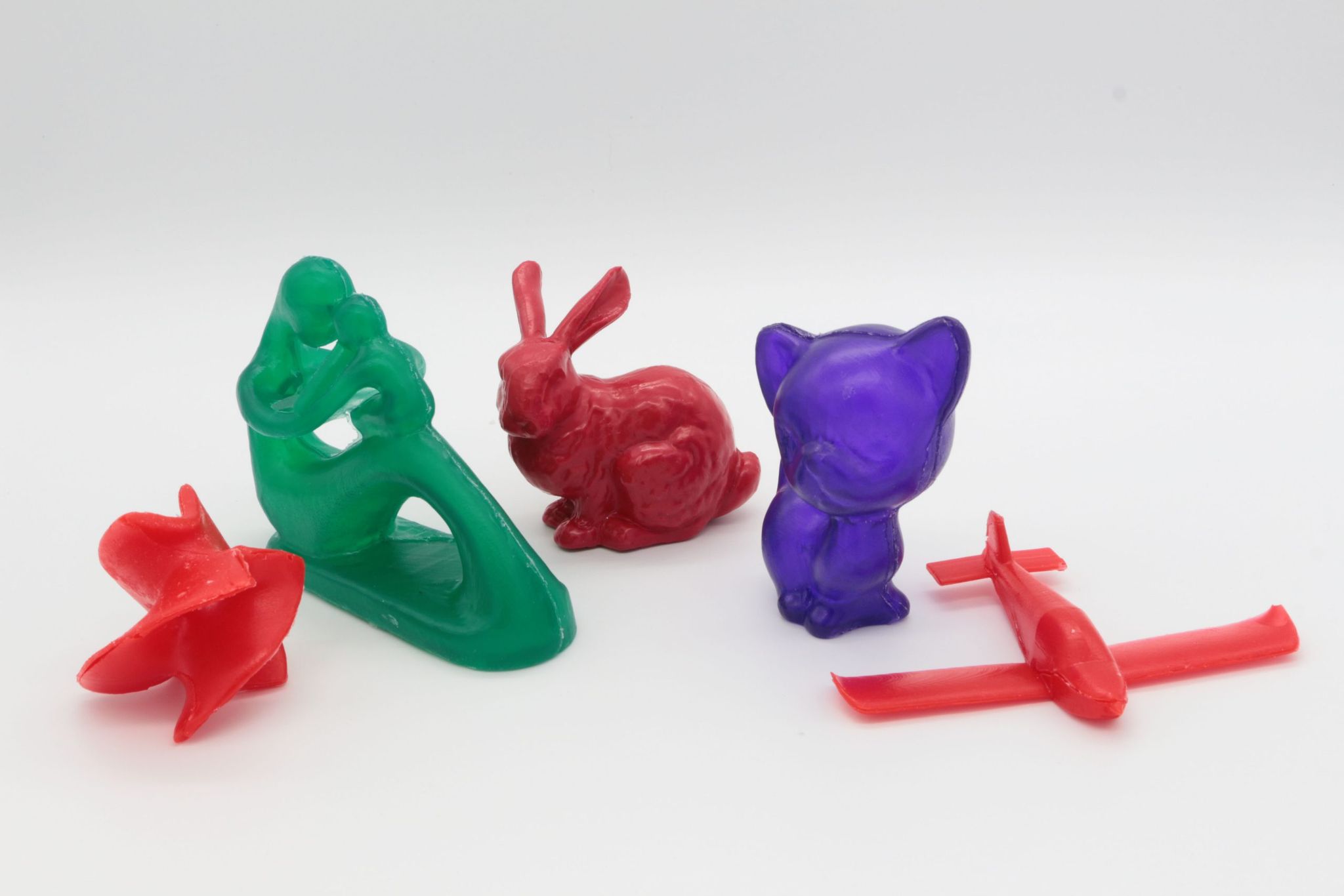 Cast objects in red, green and purple resin, including a bunny and a cat, made with two-piece rigid moulds